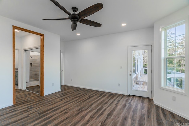 empty room with dark hardwood / wood-style flooring and ceiling fan