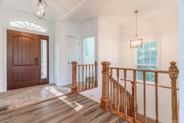 foyer featuring hardwood / wood-style floors and a chandelier