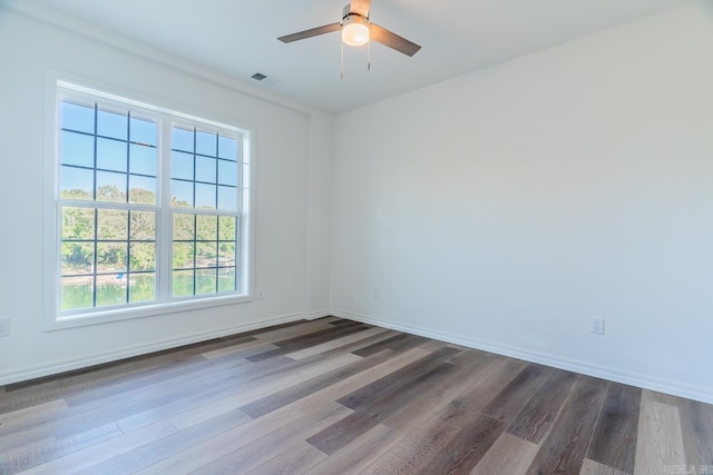 spare room with hardwood / wood-style floors and ceiling fan