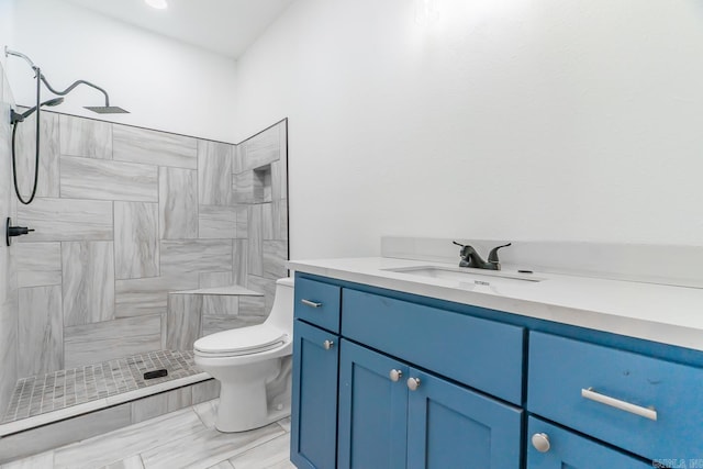 bathroom featuring a shower, vanity, and toilet