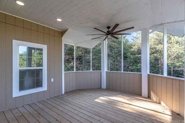 unfurnished sunroom featuring wood ceiling and ceiling fan