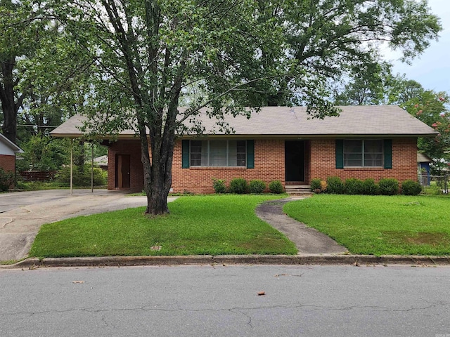 view of front of property with a front lawn and a carport