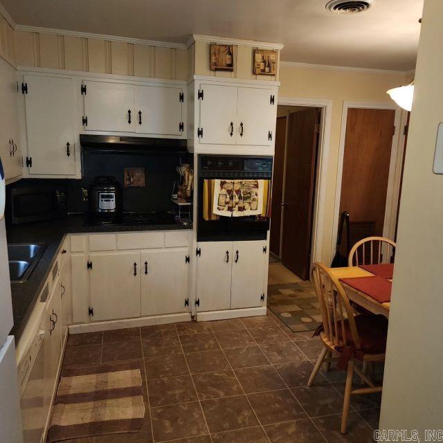 kitchen featuring ornamental molding, white cabinetry, and black appliances