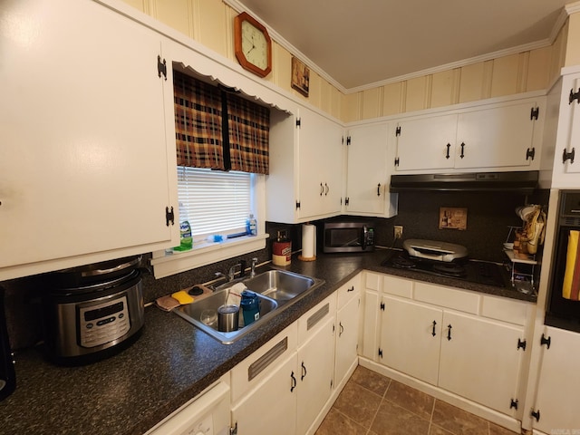 kitchen with sink, white cabinets, decorative backsplash, black appliances, and ornamental molding