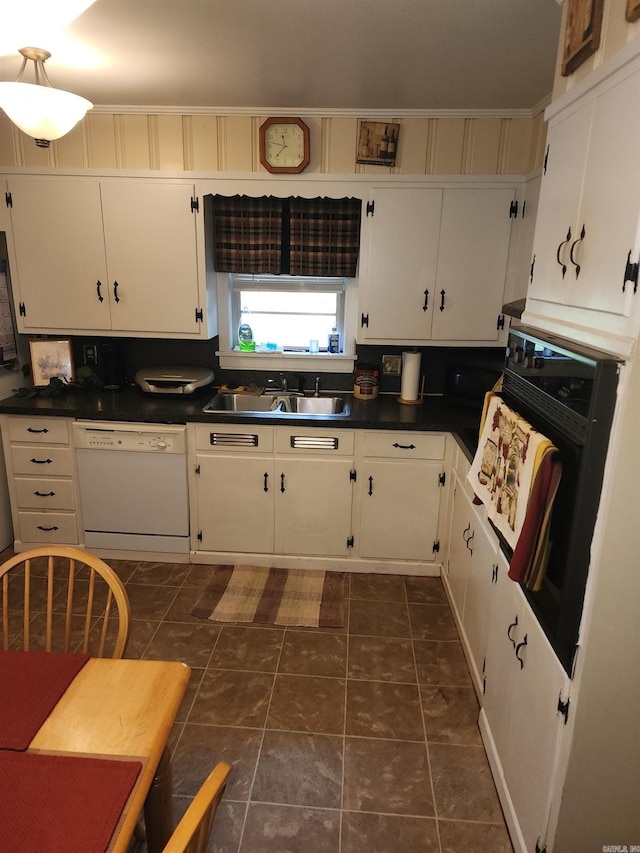 kitchen featuring oven, dishwasher, sink, and white cabinets