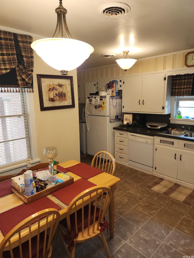 kitchen with white appliances, white cabinetry, a healthy amount of sunlight, and sink