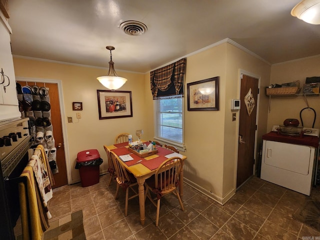 dining area featuring ornamental molding and washer / dryer