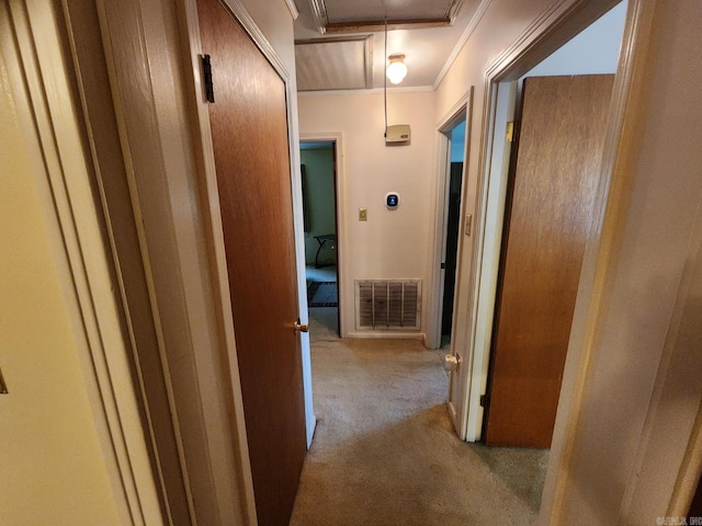 hall featuring crown molding and light colored carpet