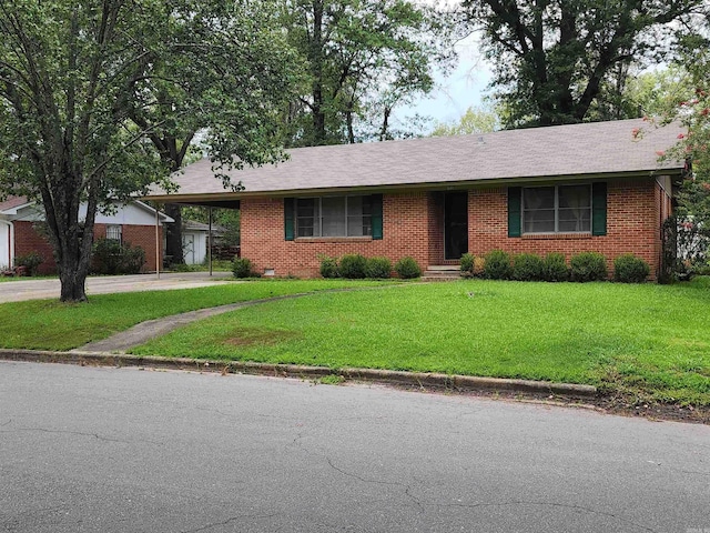 ranch-style home with a carport and a front lawn