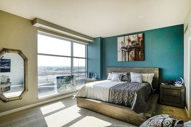 bedroom with multiple windows and carpet floors