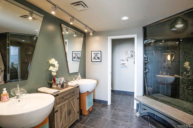 bathroom with vanity, tile patterned floors, and tiled shower