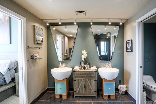 bathroom featuring vanity, tile patterned flooring, toilet, and rail lighting