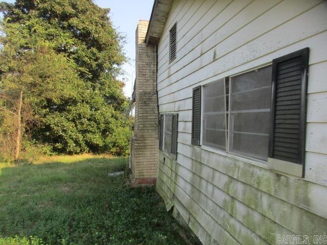 view of side of home featuring a lawn