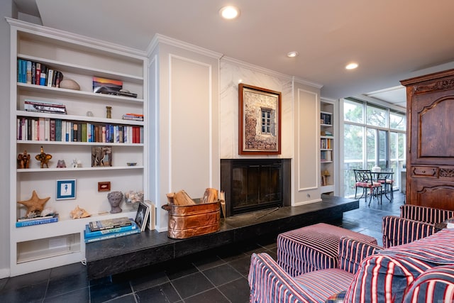 living area featuring built in features and dark tile patterned floors