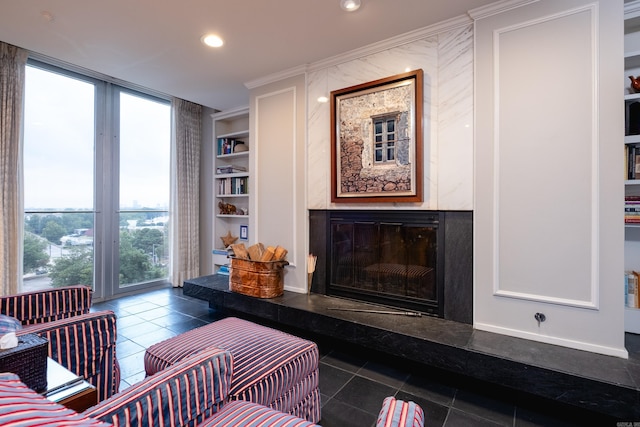 tiled living room featuring ornamental molding, built in shelves, and a premium fireplace