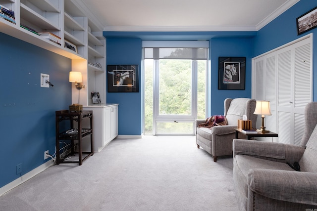 sitting room with carpet floors and ornamental molding