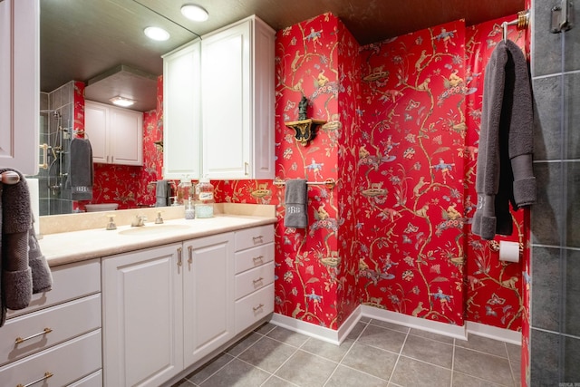 bathroom with tile patterned flooring, walk in shower, and vanity