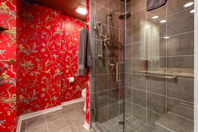 bathroom with tile patterned flooring, a shower with door, and toilet