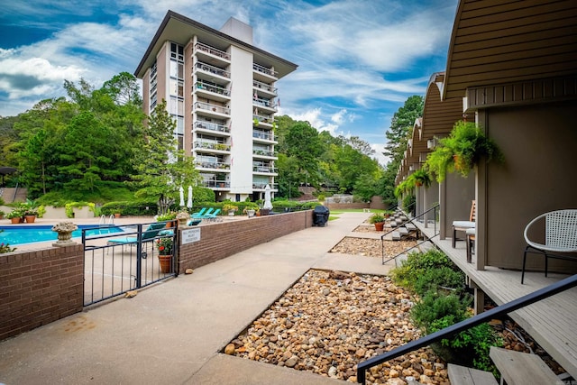 view of home's community featuring a patio and a swimming pool