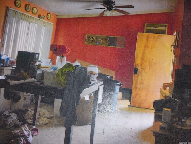 dining space with ceiling fan and a wall mounted air conditioner