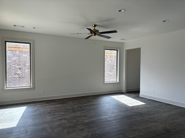 unfurnished room with dark hardwood / wood-style floors and ceiling fan