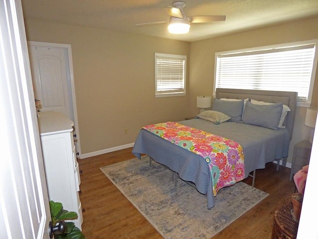 bedroom with ceiling fan and dark hardwood / wood-style floors