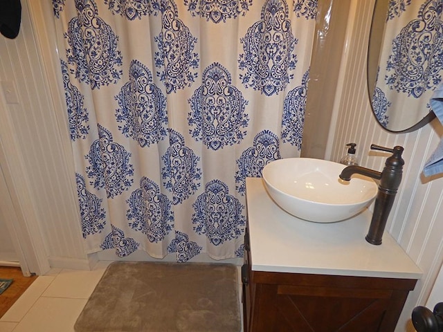 bathroom featuring curtained shower, tile patterned floors, and vanity