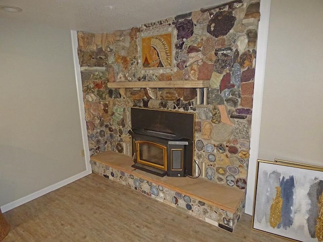 details featuring hardwood / wood-style floors and a wood stove