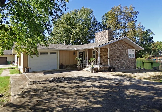 ranch-style home with a porch and a garage