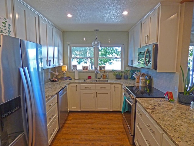 kitchen featuring stainless steel appliances, dark wood-type flooring, sink, and white cabinetry