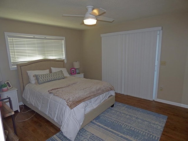 bedroom with ceiling fan and dark hardwood / wood-style flooring