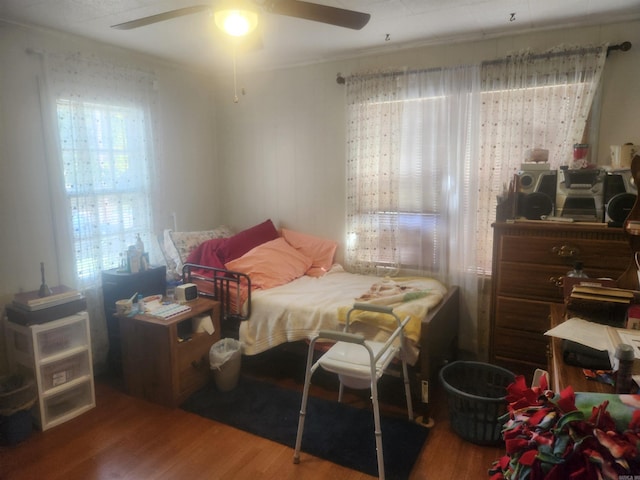 bedroom with ceiling fan, hardwood / wood-style flooring, and ornamental molding