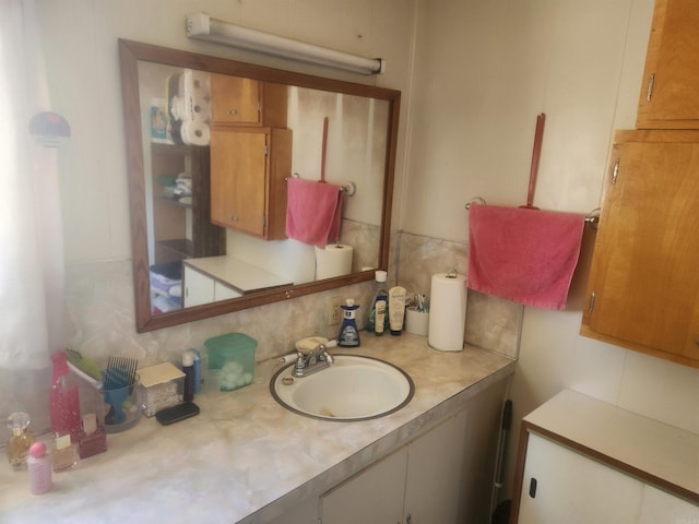 bathroom with vanity and backsplash