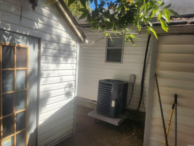 details featuring central AC unit and wood walls