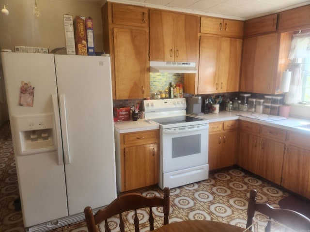 kitchen with white appliances and decorative backsplash