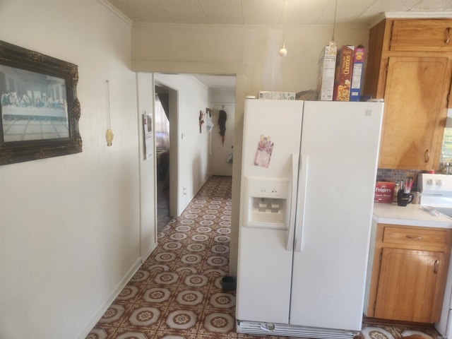 kitchen featuring crown molding and white appliances