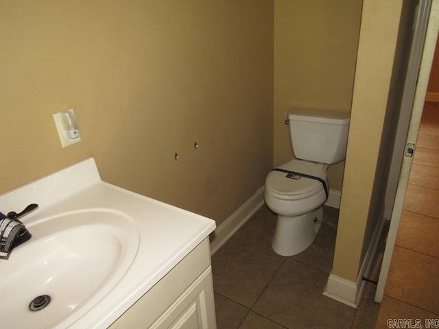 bathroom featuring tile patterned floors, vanity, and toilet