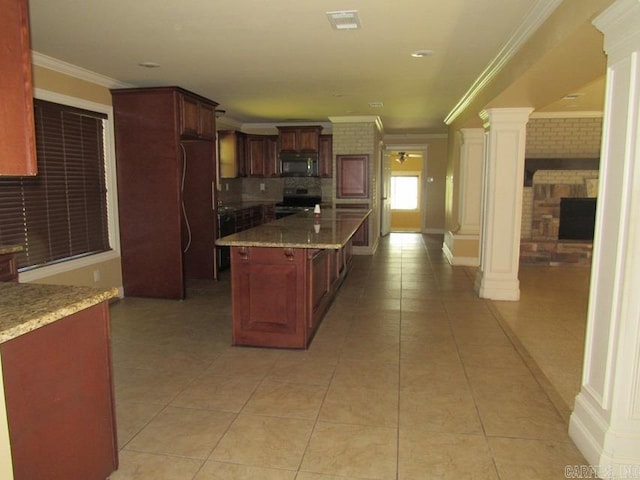 kitchen featuring a kitchen island, decorative columns, light stone counters, black appliances, and light tile patterned floors