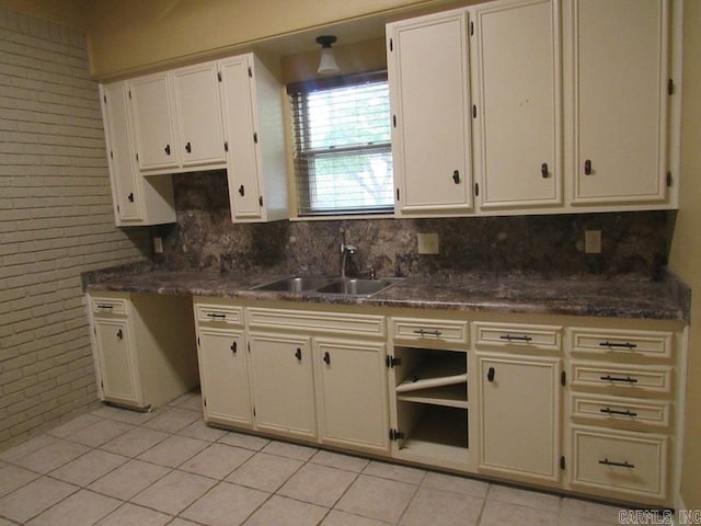 kitchen featuring light tile patterned flooring and sink