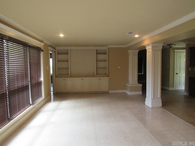 unfurnished living room with crown molding and decorative columns