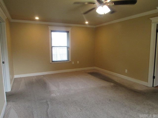 empty room with ornamental molding, ceiling fan, and light colored carpet