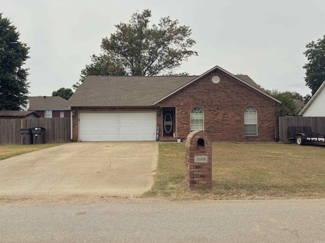 view of front of home featuring a front lawn and a garage