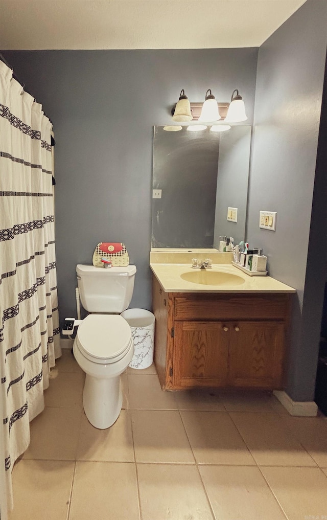 bathroom with tile patterned flooring, curtained shower, vanity, and toilet