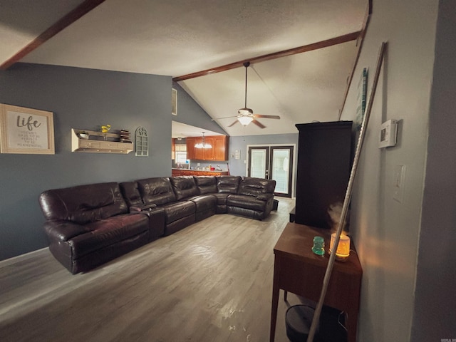 living room with ceiling fan, vaulted ceiling with beams, and light hardwood / wood-style floors