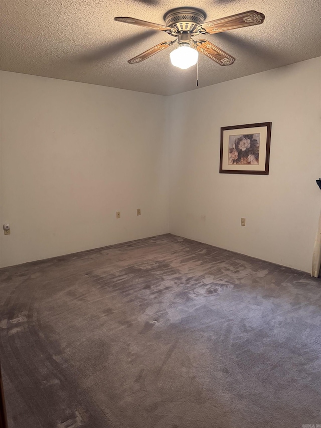 carpeted empty room featuring a textured ceiling and ceiling fan