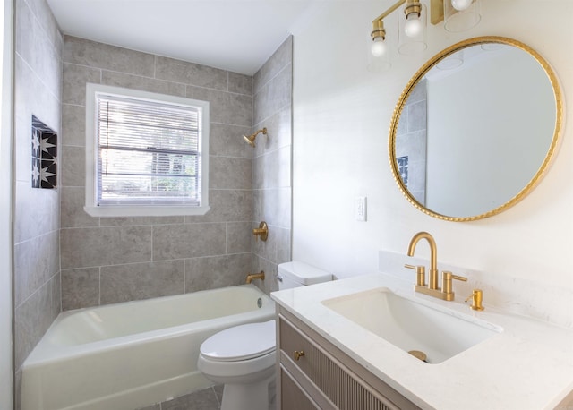 full bathroom featuring vanity, tile patterned flooring, toilet, and tiled shower / bath combo