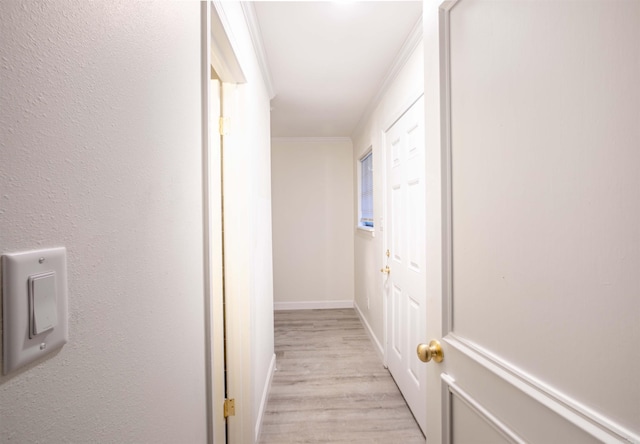 hall with crown molding and light wood-type flooring