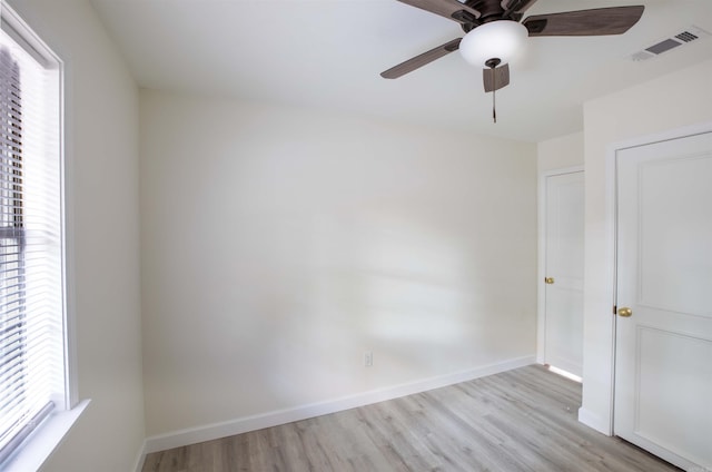 unfurnished bedroom featuring ceiling fan, light hardwood / wood-style flooring, and multiple windows