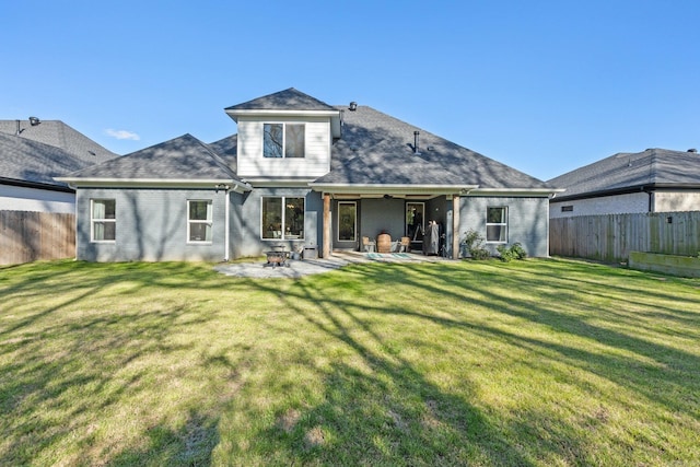 rear view of house featuring a yard and a patio area