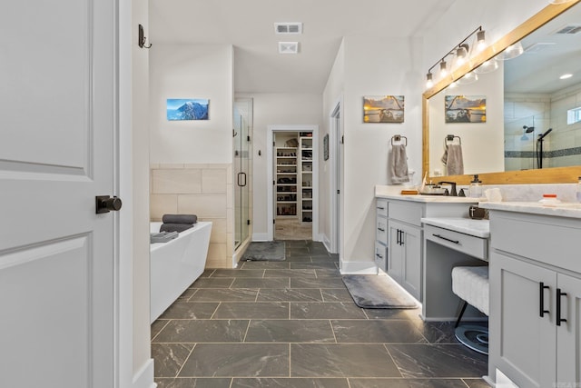 bathroom with vanity and separate shower and tub